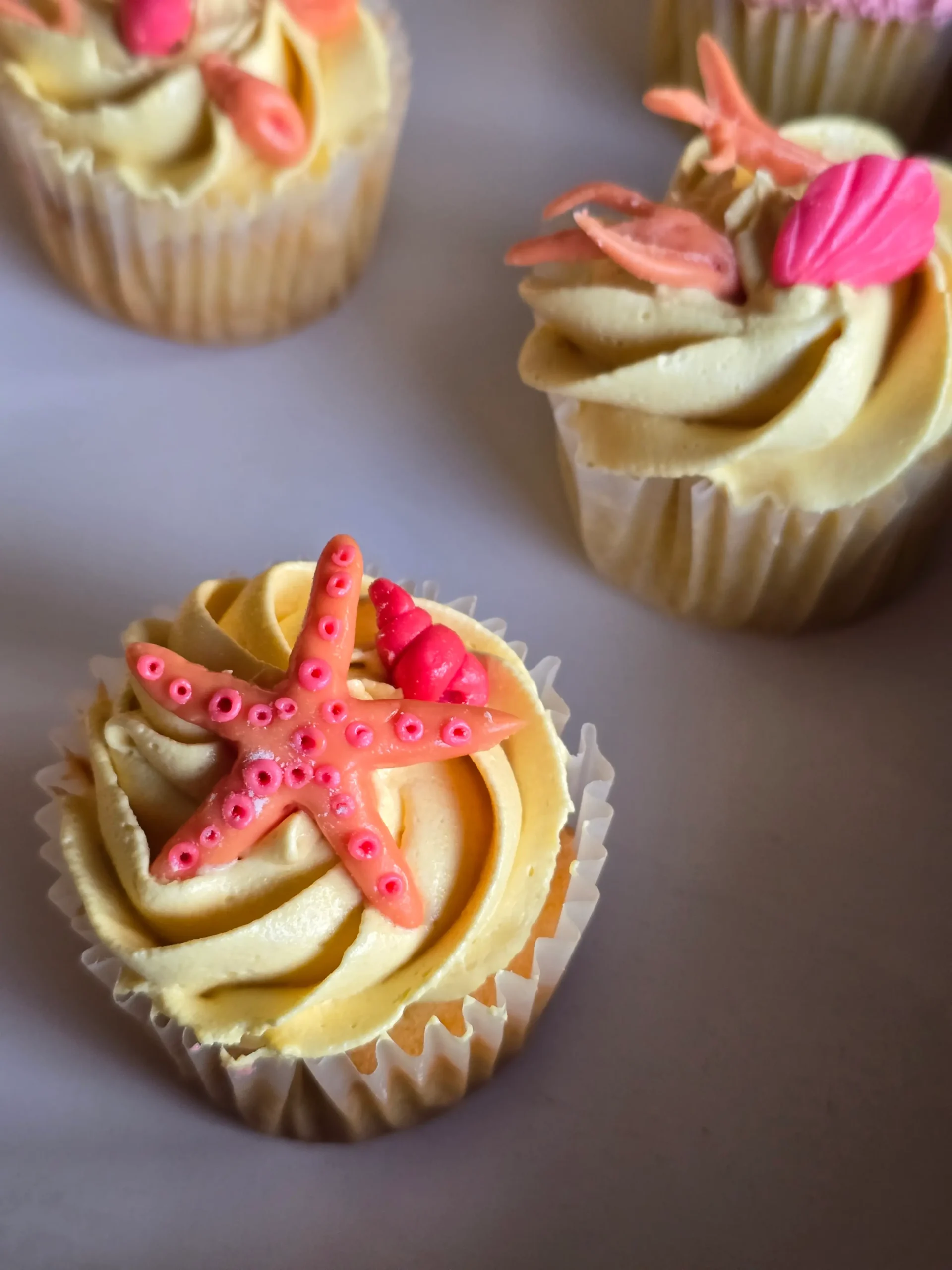 Vanilla Cupcakes with buttercream frosting and fondant starfish and shell decoration