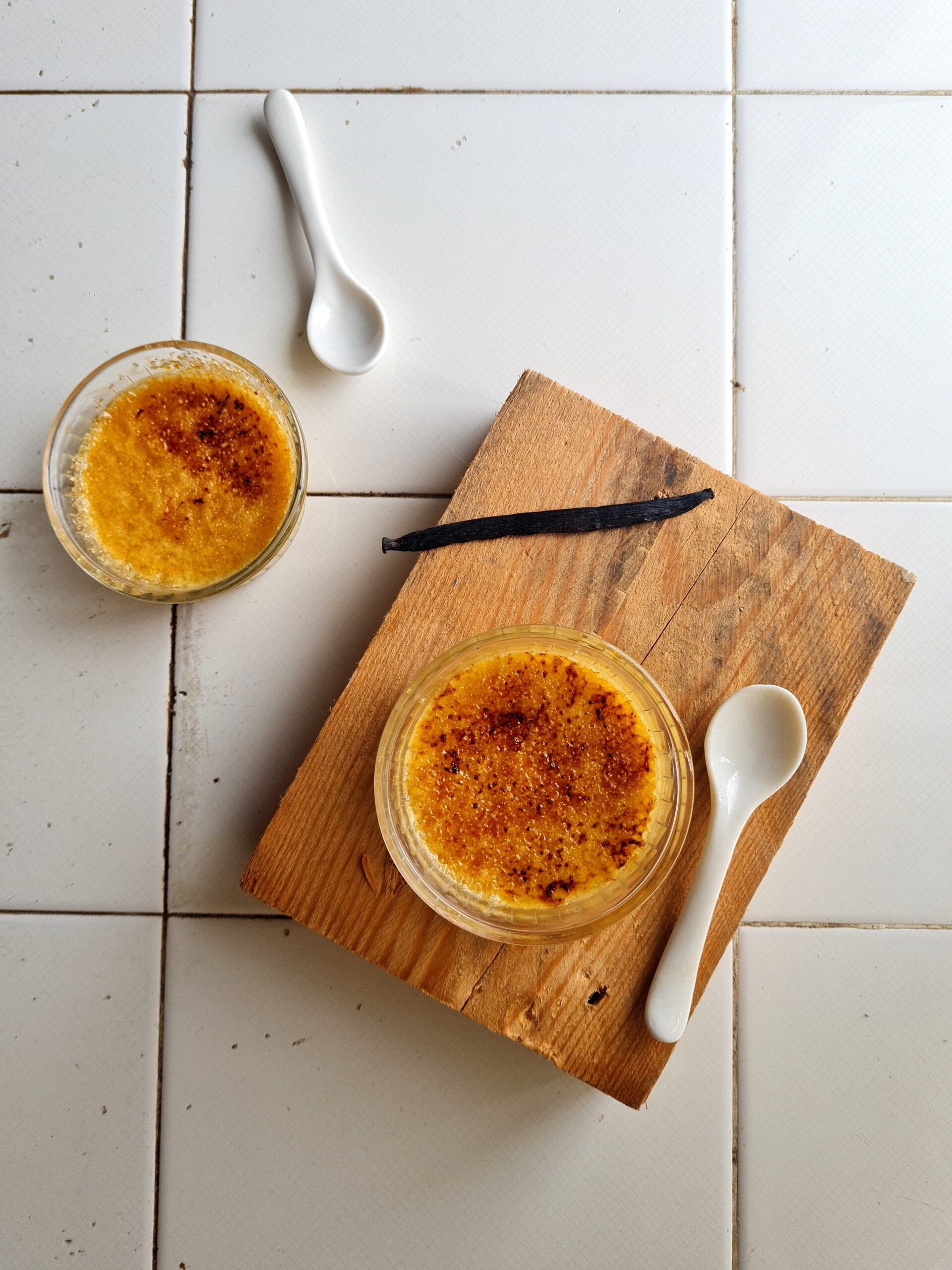 Classic crème brûlée recipe served in white ramekins with caramelized sugar topping.