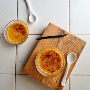 Classic crème brûlée recipe served in white ramekins with caramelized sugar topping.