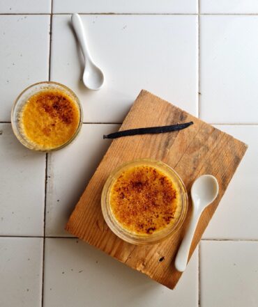 Classic crème brûlée recipe served in white ramekins with caramelized sugar topping.